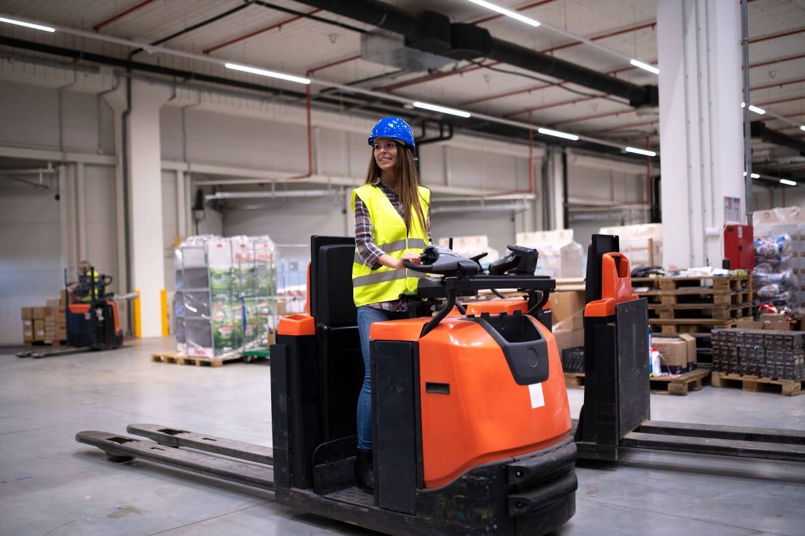 Warehouse worker operating a modern forklift inside a logistics facility, showcasing equipment provided by professional Forklift Suppliers in Dubai